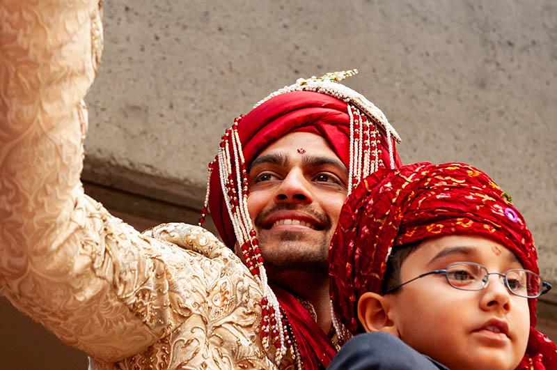 Hindu Groom and young cousin on horse during Baraat